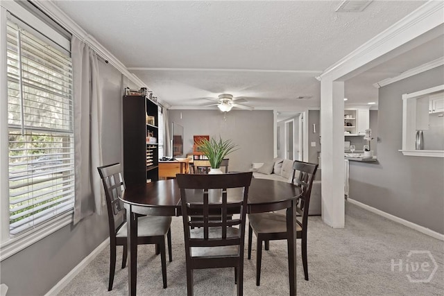 24 Mimosa St, Midway, GA 31320 - carpeted dining space featuring ceiling fan, a textured ceiling, baseboards, and ornamental molding