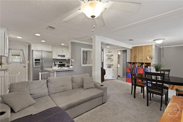 24 Mimosa St, Midway, GA 31320 - living room with ornamental molding, a textured ceiling, a ceiling fan, recessed lighting, and light colored carpet