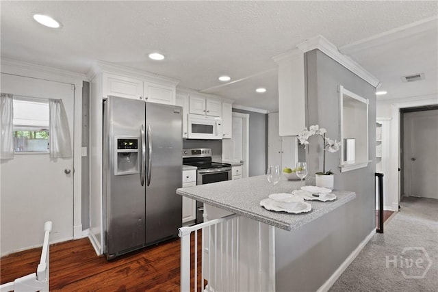 24 Mimosa St, Midway, GA 31320 - kitchen featuring stainless steel appliances, baseboards, white cabinetry, recessed lighting, and crown molding