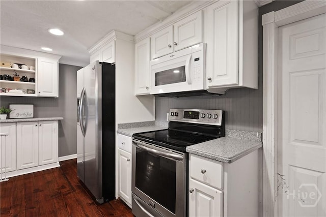 24 Mimosa St, Midway, GA 31320 - kitchen with appliances with stainless steel finishes, light countertops, dark wood-type flooring, white cabinetry, and recessed lighting