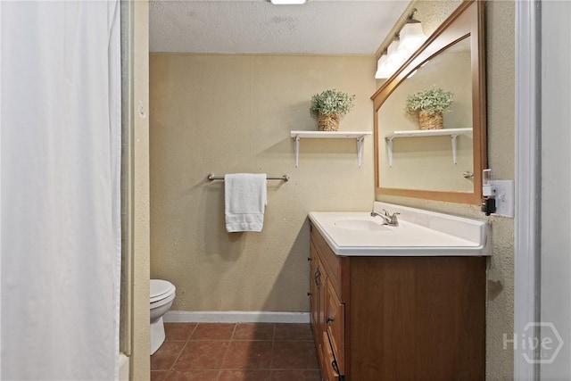 24 Mimosa St, Midway, GA 31320 - bathroom featuring vanity, toilet, tile patterned floors, baseboards, and a textured ceiling
