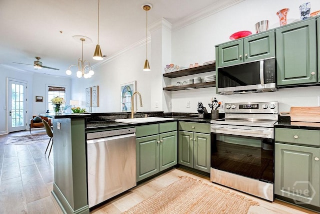329 W Charlton St, Savannah, GA 31401 - kitchen with appliances with stainless steel finishes, green cabinets, a sink, and ornamental molding