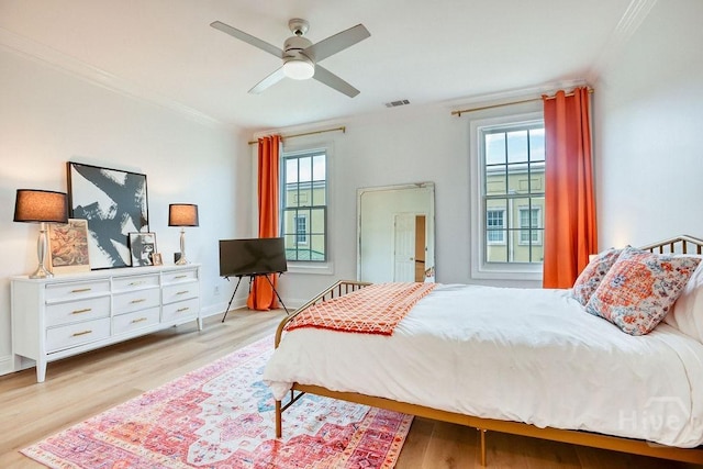 329 W Charlton St, Savannah, GA 31401 - bedroom with multiple windows, crown molding, light wood-style flooring, baseboards, and a ceiling fan