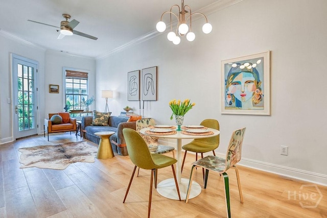 329 W Charlton St, Savannah, GA 31401 - dining room with crown molding, light wood-style floors, baseboards, ceiling fan, and a chandelier