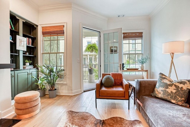 329 W Charlton St, Savannah, GA 31401 - living area with hardwood / wood-style floors, baseboards, and crown molding