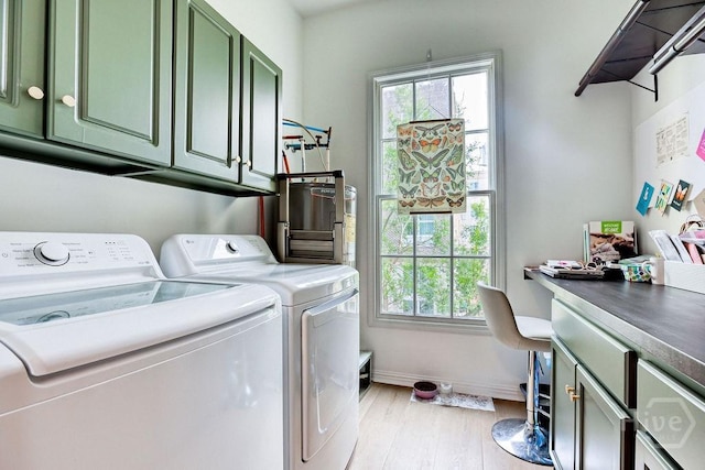 329 W Charlton St, Savannah, GA 31401 - laundry room featuring separate washer and dryer, cabinet space, light wood-style floors, and baseboards