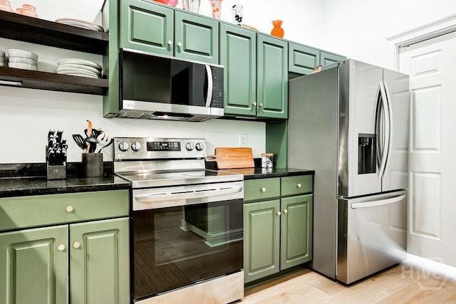 329 W Charlton St, Savannah, GA 31401 - kitchen featuring appliances with stainless steel finishes, green cabinetry, open shelves, and dark stone countertops
