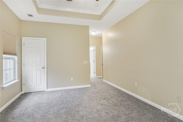 817 Granite Ln, Savannah, GA 31419 - carpeted spare room featuring a tray ceiling, a ceiling fan, and baseboards