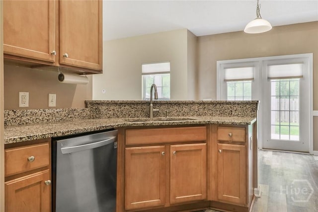 817 Granite Ln, Savannah, GA 31419 - kitchen featuring dishwasher, a sink, healthy amount of natural light, and light stone countertops