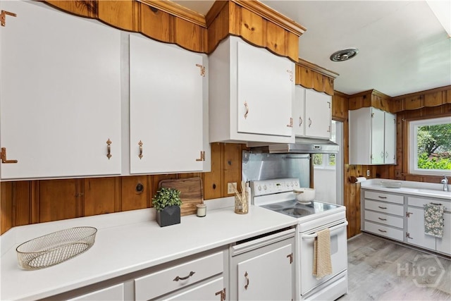 1525 Whitney Rd, Savannah, GA 31406 - kitchen featuring white range with electric stovetop, light countertops, under cabinet range hood, light wood-style floors, and white cabinetry