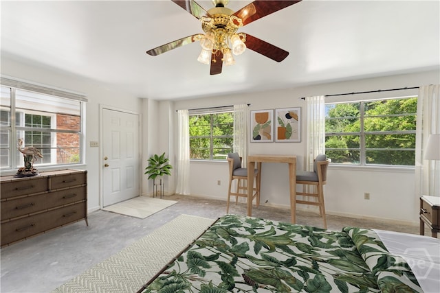 1525 Whitney Rd, Savannah, GA 31406 - bedroom featuring multiple windows, ceiling fan, and concrete floors