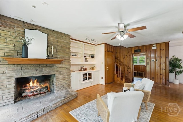 1525 Whitney Rd, Savannah, GA 31406 - living room with a ceiling fan, stairway, a large fireplace, and wood finished floors