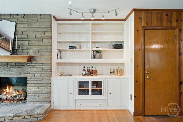 1525 Whitney Rd, Savannah, GA 31406 - bar area featuring light wood finished floors, a stone fireplace, and built in features
