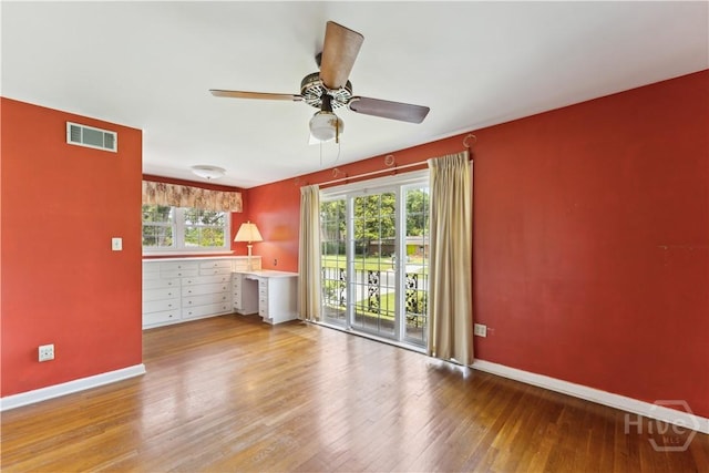 1525 Whitney Rd, Savannah, GA 31406 - unfurnished room with baseboards, wood-type flooring, a ceiling fan, and plenty of natural light