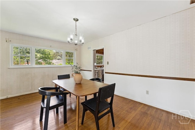 1525 Whitney Rd, Savannah, GA 31406 - dining room featuring a chandelier, plenty of natural light, hardwood / wood-style floors, baseboards, and wallpapered walls