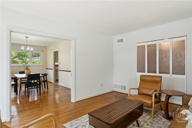 1525 Whitney Rd, Savannah, GA 31406 - living area featuring a chandelier, wood finished floors, and baseboards