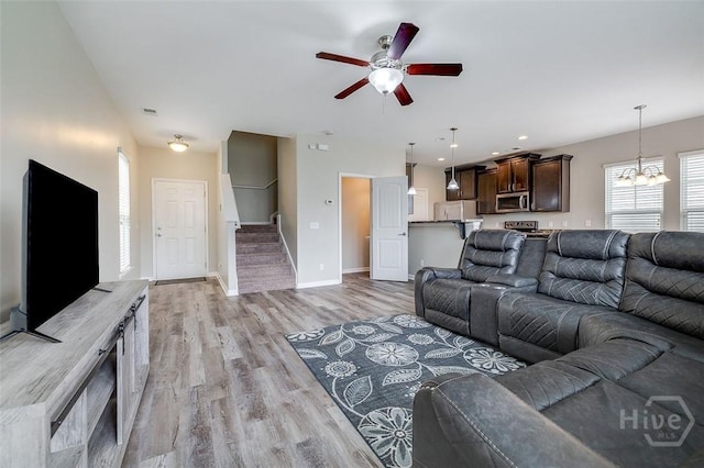 141 Lakepointe Dr, Savannah, GA 31407 - living room featuring a chandelier, stairway, ceiling fan, light wood finished floors, and baseboards