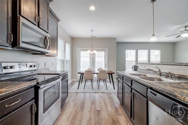 141 Lakepointe Dr, Savannah, GA 31407 - kitchen featuring stainless steel appliances, a sink, dark countertops, light wood-style flooring, and dark brown cabinets