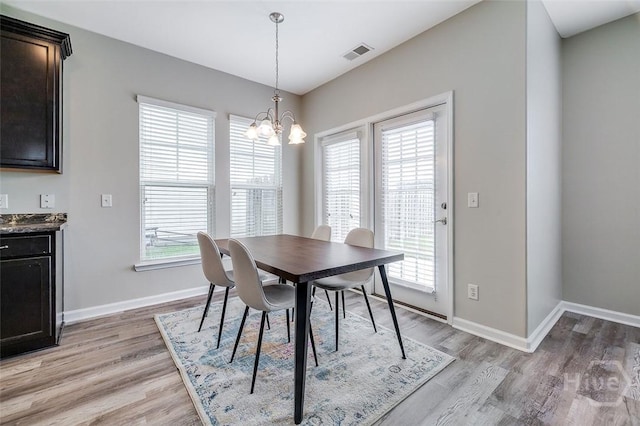 141 Lakepointe Dr, Savannah, GA 31407 - dining space featuring baseboards, light wood-type flooring, and a chandelier