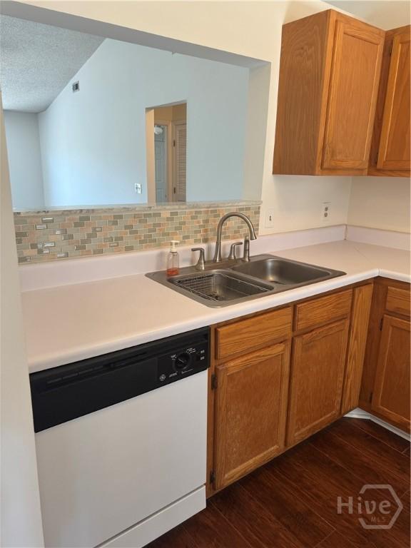142 Bull River Bluff Dr, Savannah, GA 31410 - kitchen featuring dishwasher, a sink, dark wood-style flooring, light countertops, and a textured ceiling