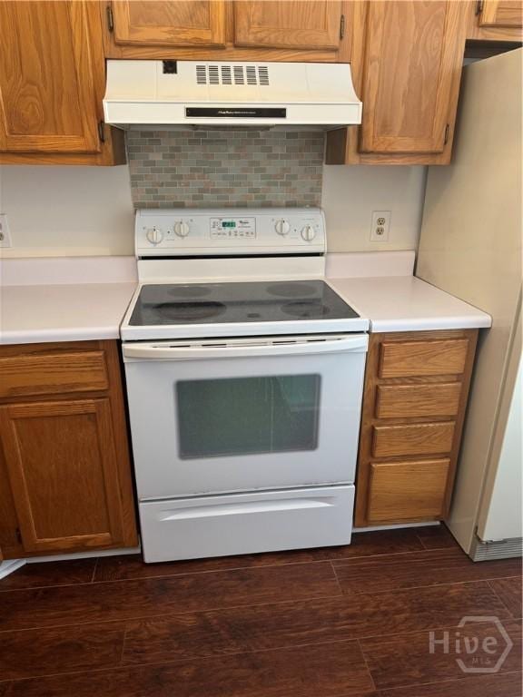 142 Bull River Bluff Dr, Savannah, GA 31410 - kitchen with white appliances, under cabinet range hood, light countertops, and brown cabinetry