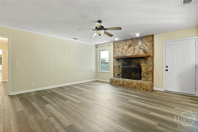 203 Whittington Dr, Savannah, GA 31419 - unfurnished living room with ceiling fan, wood finished floors, baseboards, a textured ceiling, and a fireplace