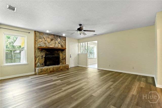 203 Whittington Dr, Savannah, GA 31419 - unfurnished living room with a textured ceiling, a fireplace, a ceiling fan, baseboards, and wood finished floors