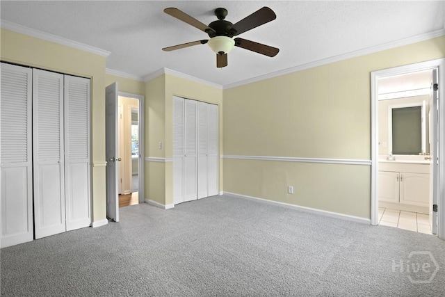 203 Whittington Dr, Savannah, GA 31419 - unfurnished bedroom with two closets, carpet floors, crown molding, baseboards, and ensuite bathroom