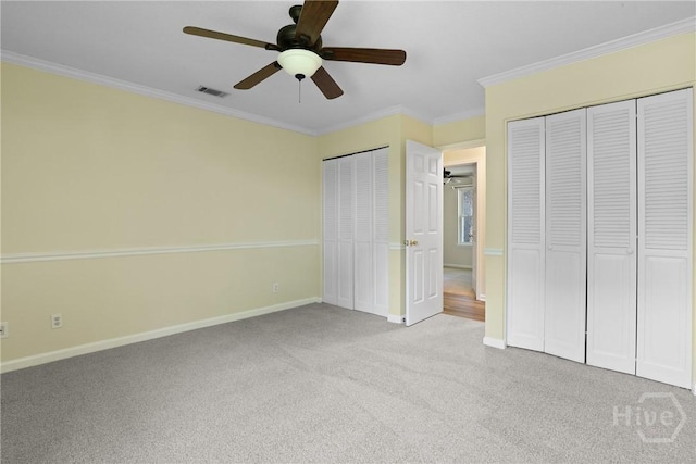 203 Whittington Dr, Savannah, GA 31419 - unfurnished bedroom featuring two closets, carpet, crown molding, baseboards, and ceiling fan