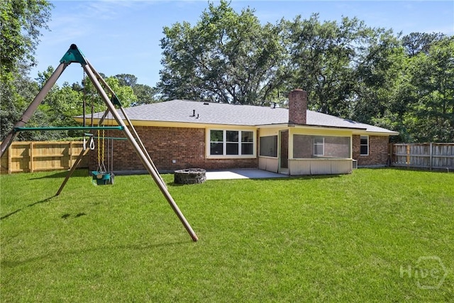 203 Whittington Dr, Savannah, GA 31419 - back of property featuring a playground, a patio area, brick siding, and a chimney