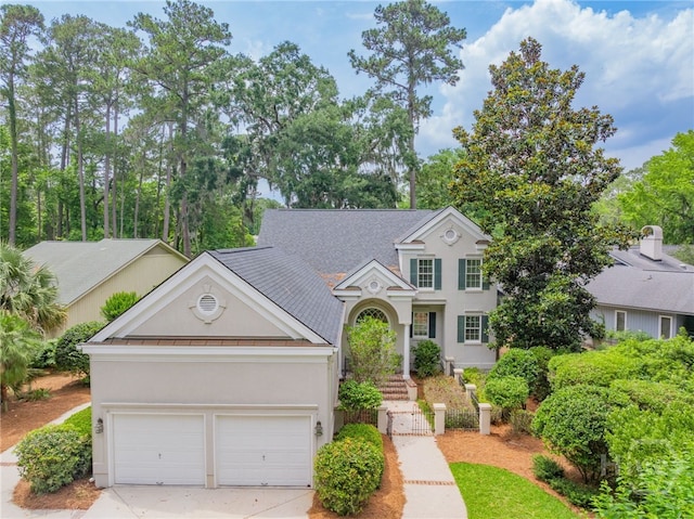 2 Franklin Creek Rd S, Savannah, GA 31411 - traditional home with stucco siding, driveway, and roof with shingles