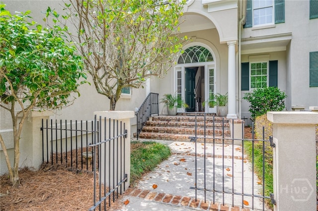 2 Franklin Creek Rd S, Savannah, GA 31411 - property entrance with stucco siding and a gate