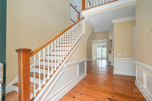 2 Franklin Creek Rd S, Savannah, GA 31411 - stairway with wood-type flooring, a wainscoted wall, a decorative wall, and ornamental molding