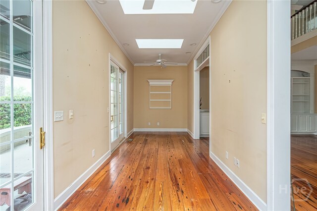 2 Franklin Creek Rd S, Savannah, GA 31411 - hall featuring a skylight, hardwood / wood-style floors, plenty of natural light, baseboards, and crown molding