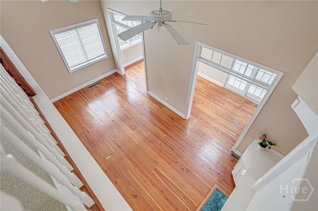 2 Franklin Creek Rd S, Savannah, GA 31411 - unfurnished living room with light wood-style floors, a ceiling fan, and baseboards