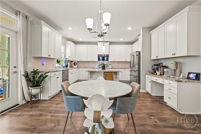 333 Waverly Ln, Richmond Hill, GA 31324 - kitchen featuring stainless steel appliances, plenty of natural light, a kitchen island, dark wood-style floors, and recessed lighting