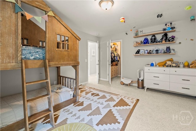 333 Waverly Ln, Richmond Hill, GA 31324 - bedroom featuring a closet, light colored carpet, a walk in closet, and baseboards