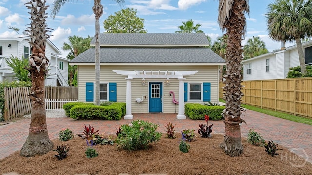1406 Jones Ave, Tybee Island, GA 31328 - view of front of house featuring a pergola and a shingled roof
