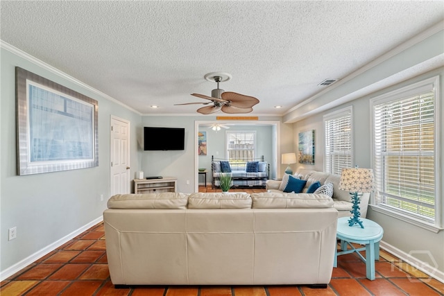 1406 Jones Ave, Tybee Island, GA 31328 - living area with plenty of natural light, ornamental molding, ceiling fan, a textured ceiling, and dark tile patterned flooring