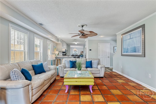 1406 Jones Ave, Tybee Island, GA 31328 - living room with crown molding, baseboards, a ceiling fan, a textured ceiling, and tile patterned floors