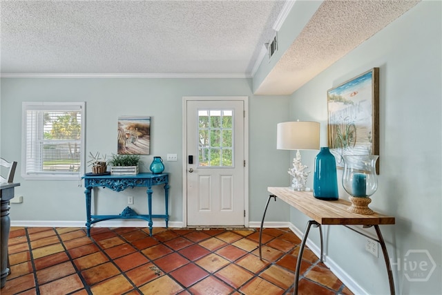 1406 Jones Ave, Tybee Island, GA 31328 - foyer with plenty of natural light, ornamental molding, a textured ceiling, baseboards, and tile patterned flooring