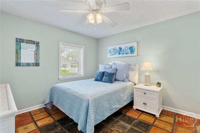 1406 Jones Ave, Tybee Island, GA 31328 - bedroom featuring a textured ceiling, baseboards, and a ceiling fan