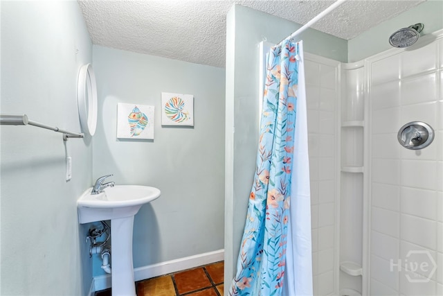 1406 Jones Ave, Tybee Island, GA 31328 - full bath with a textured ceiling, curtained shower, tile patterned flooring, and baseboards