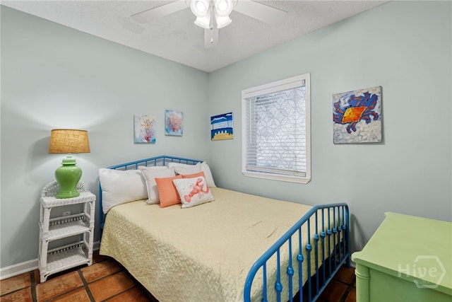 1406 Jones Ave, Tybee Island, GA 31328 - bedroom featuring tile patterned flooring, a ceiling fan, and a textured ceiling