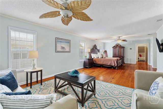1406 Jones Ave, Tybee Island, GA 31328 - bedroom featuring crown molding, a textured ceiling, wood finished floors, and ceiling fan