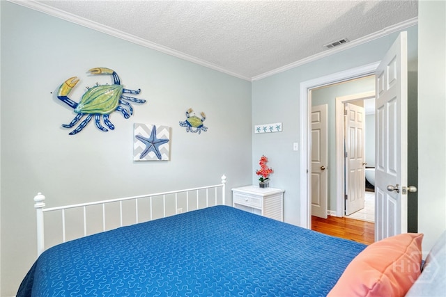 1406 Jones Ave, Tybee Island, GA 31328 - bedroom with wood finished floors, crown molding, and a textured ceiling