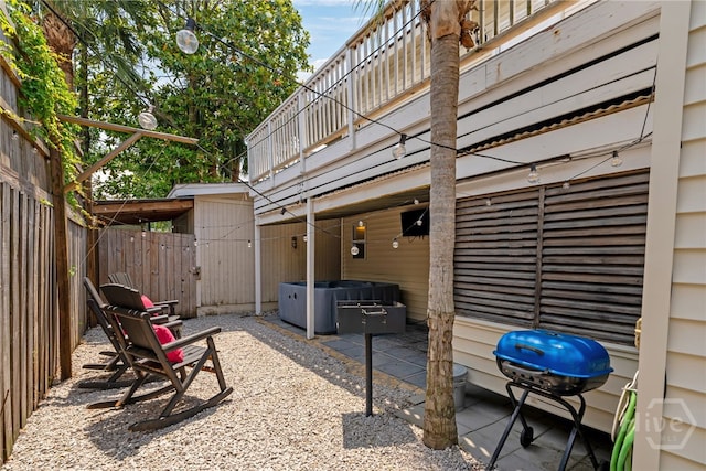 1406 Jones Ave, Tybee Island, GA 31328 - fenced backyard with a hot tub, a patio area, and area for grilling