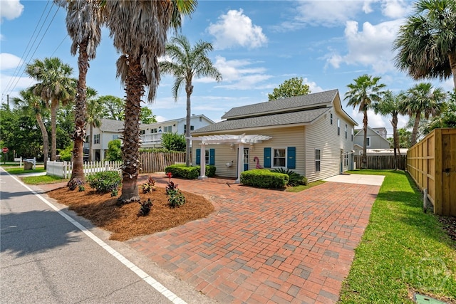 1406 Jones Ave, Tybee Island, GA 31328 - view of front of house with a pergola and roof with shingles
