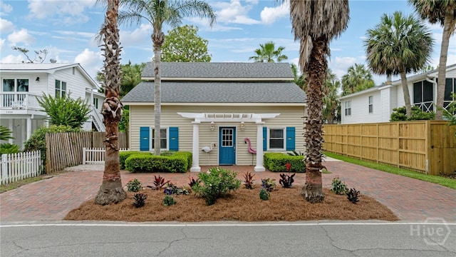 1406 Jones Ave, Tybee Island, GA 31328 - view of front of property featuring a pergola and roof with shingles