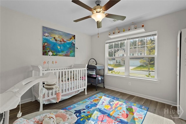 232 Cromer St, Savannah, GA 31407 - bedroom with baseboards, wood finished floors, a nursery area, and ceiling fan